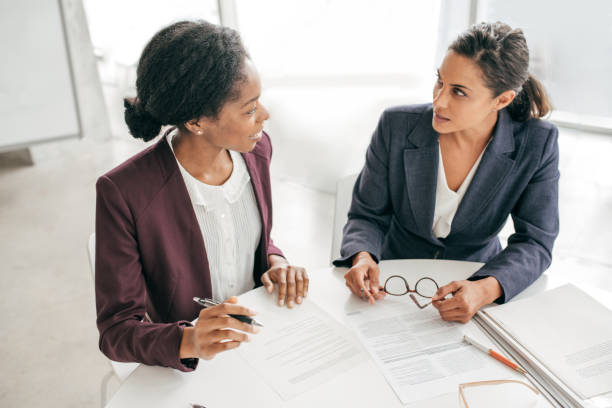 Two women discussing new contract